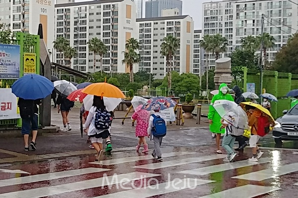 24일 오전 제주시 지역에 비가 내리면서 모 초등학교 학생들이 우산을 쓴 채 등교하고 있다. © 미디어제주