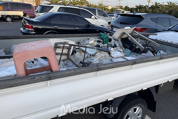 제주시 용담레포츠공원 무료 주차장에 장기방치된 트럭의 화물칸에 상당한 양의 쓰레기가 쌓여 있다. /사진=미디어제주.